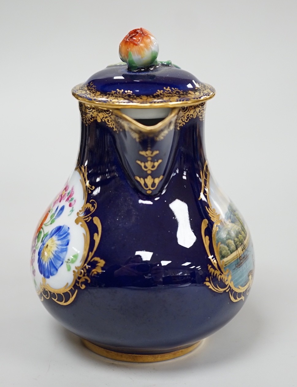 A small 19th century Meissen cobalt blue ground jug and cover, 9.5cm tall